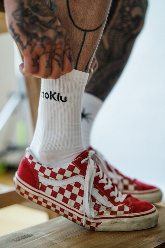 Red and white checkered sneakers with a white sock featuring 'noklu' branding.